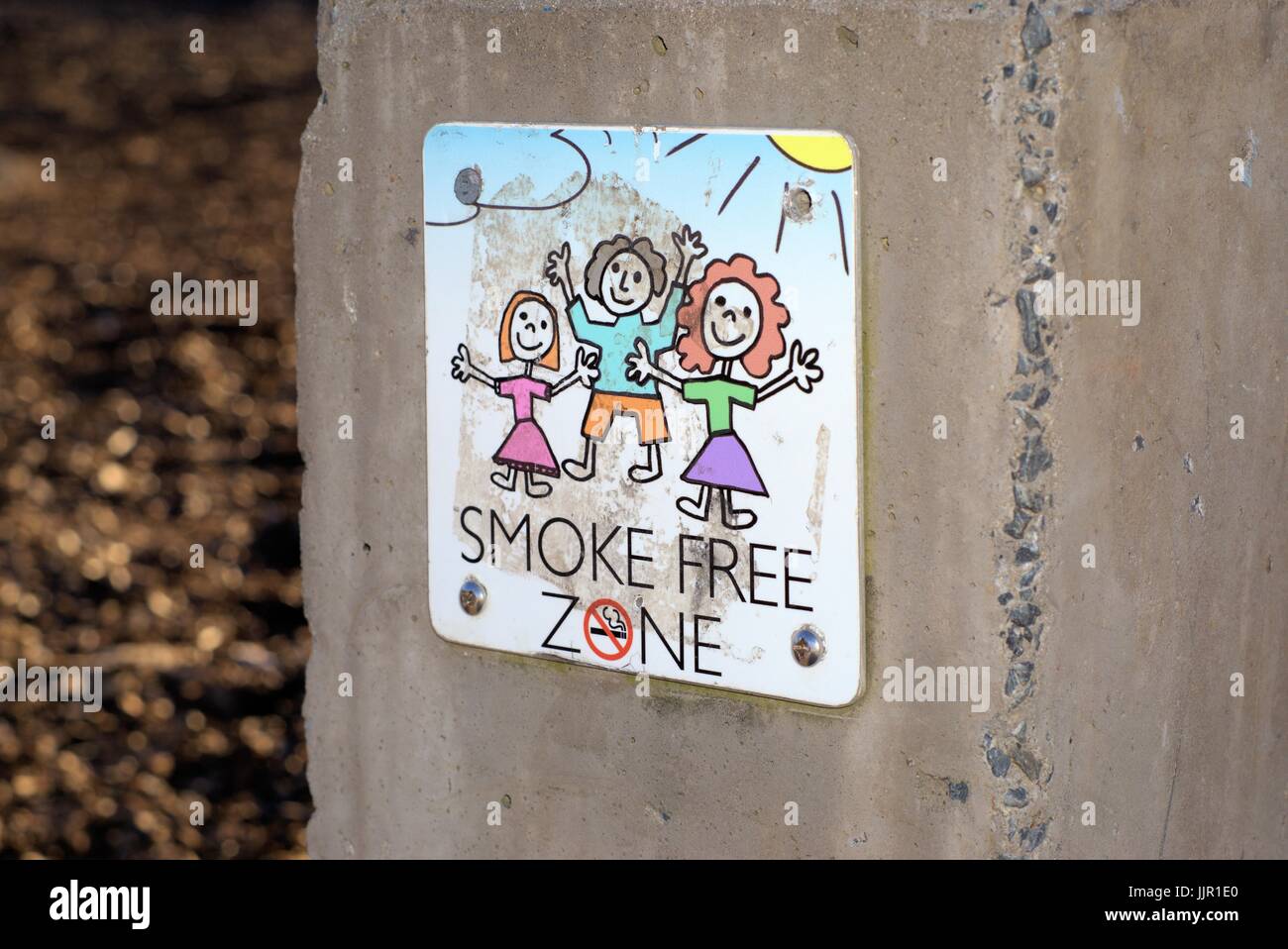 Dated 20 July 2017. Illustrative editorial use. Sign 'Smoke free zone' on wall at a public park Coffs Harbour, New South Wales, Australia Stock Photo
