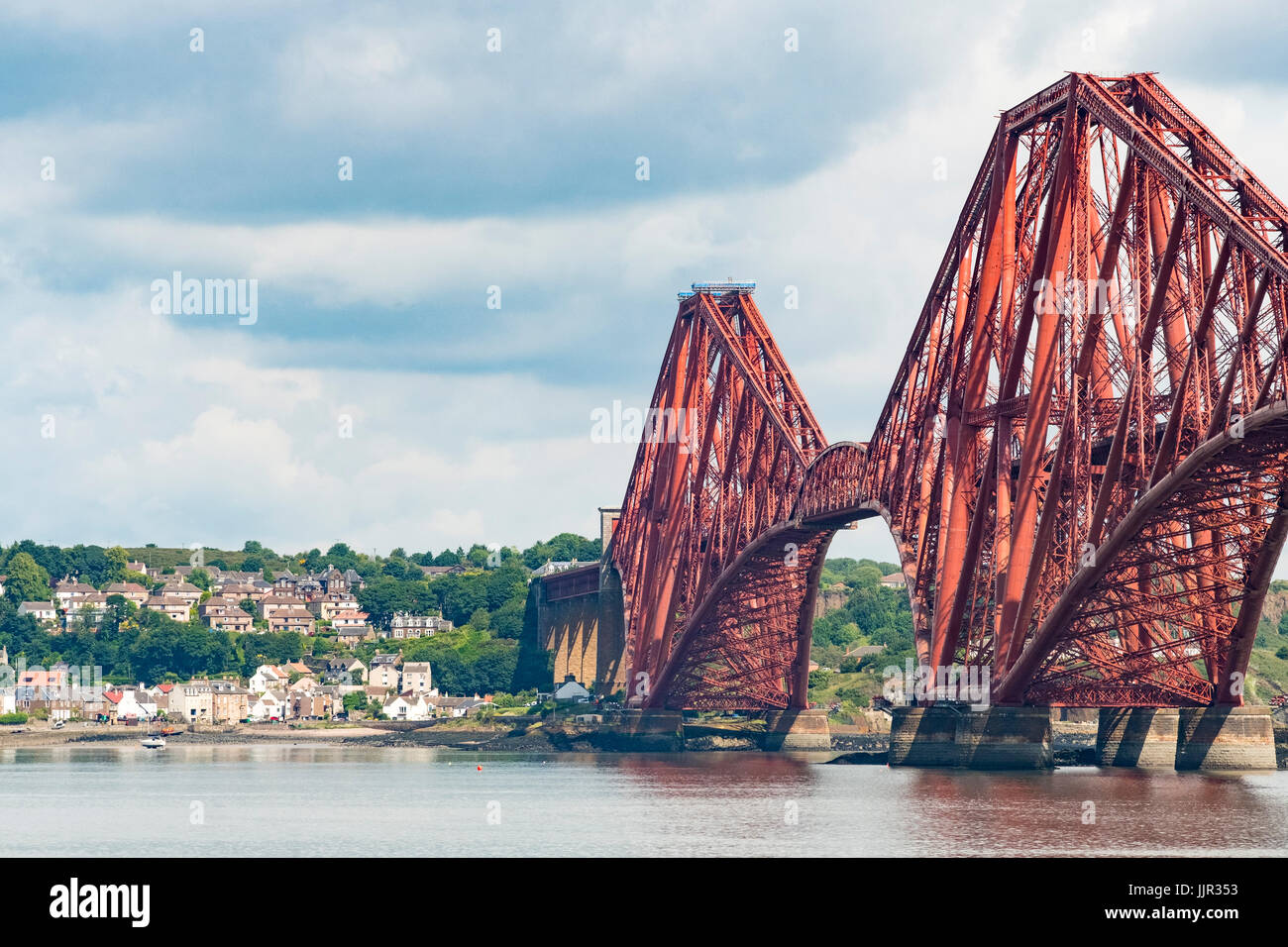 View of historic Forth Railway Bridge and village of North Queensferry from South Queensferry in Scotland, United Kingdom. Stock Photo