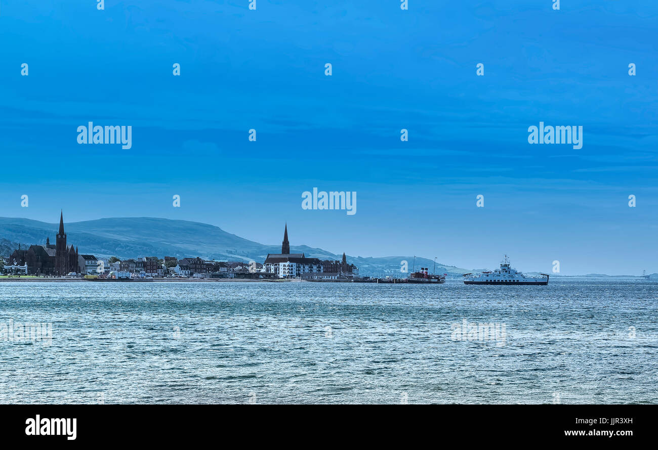 The local car ferry berthing at largs in Ayrshire. The Paddle steamer can be seen in the back ground Stock Photo