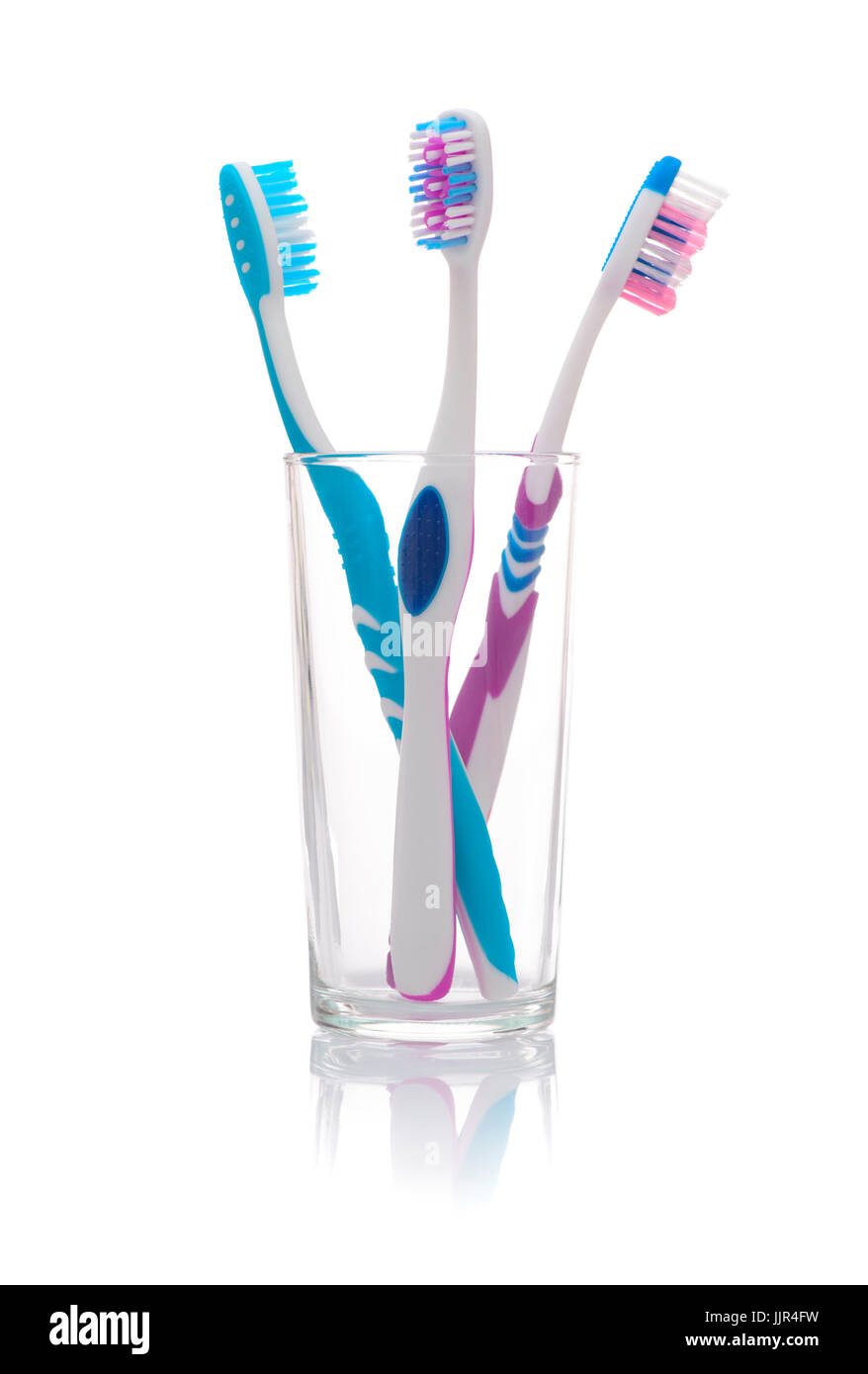 Colorful Toothbrushes in A Glass Isolated on White Stock Photo - Alamy