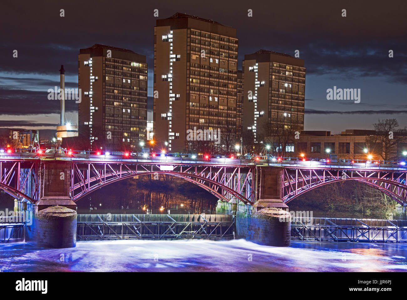 Night photograph taken from the Albery Bridge in Glasgow looking over to the illuminated Pipe Bridge and tidal weir in central Glasgow, Scotland. Stock Photo