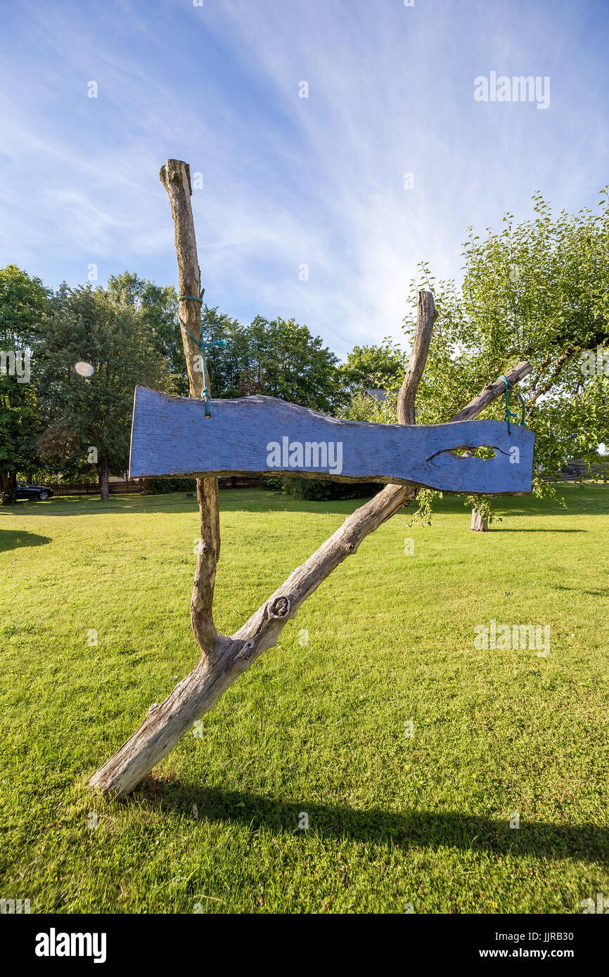 Blue sign made of wood with green grass and blue sky in background Stock Photo