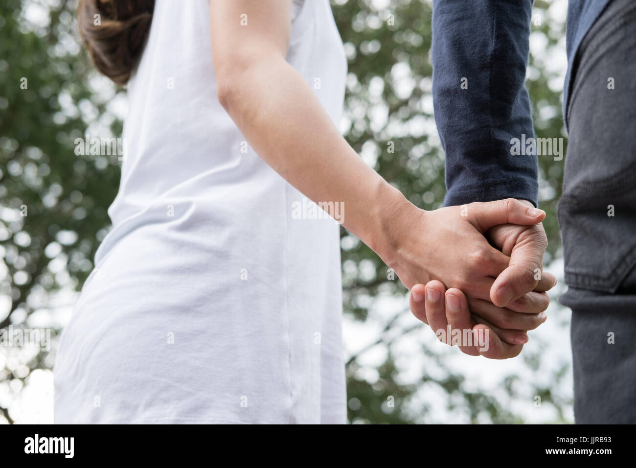 happy young asian couple holding hands in garden. Boyfriend and ...