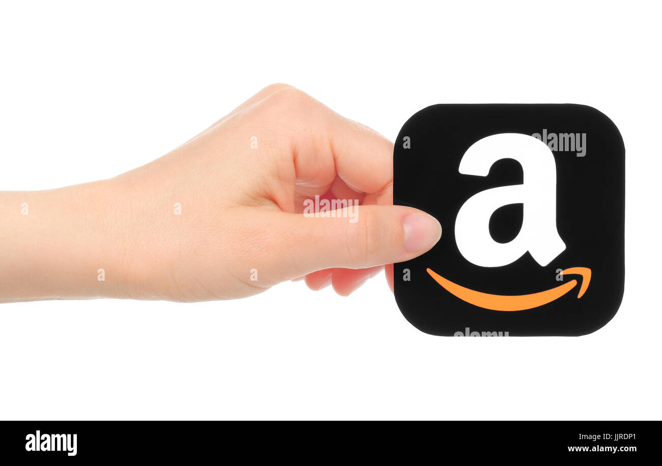 Kiev, Ukraine - May 18, 2016: Hand holds Amazon icon printed on paper. Amazon is an American electronic commerce company Stock Photo