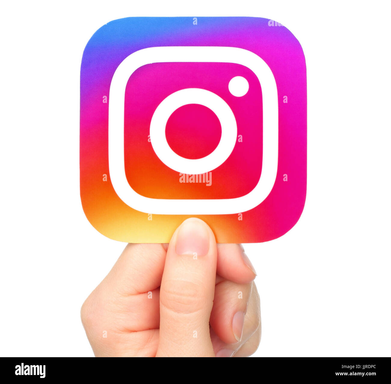Kiev, Ukraine - January 20, 2017: Hand holds Instagram icon printed on paper. Instagram is an online mobile photo-sharing, video-sharing service Stock Photo