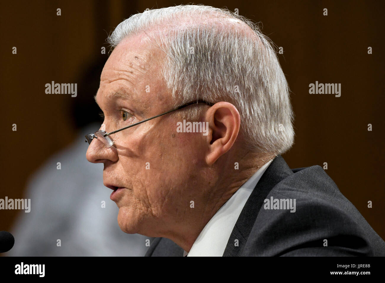 US. Attorney General Jeff Sessions peers over his reading glasses during  his response to a question from one of the members of the Senate  Intelligence Committee during his testimony in front of