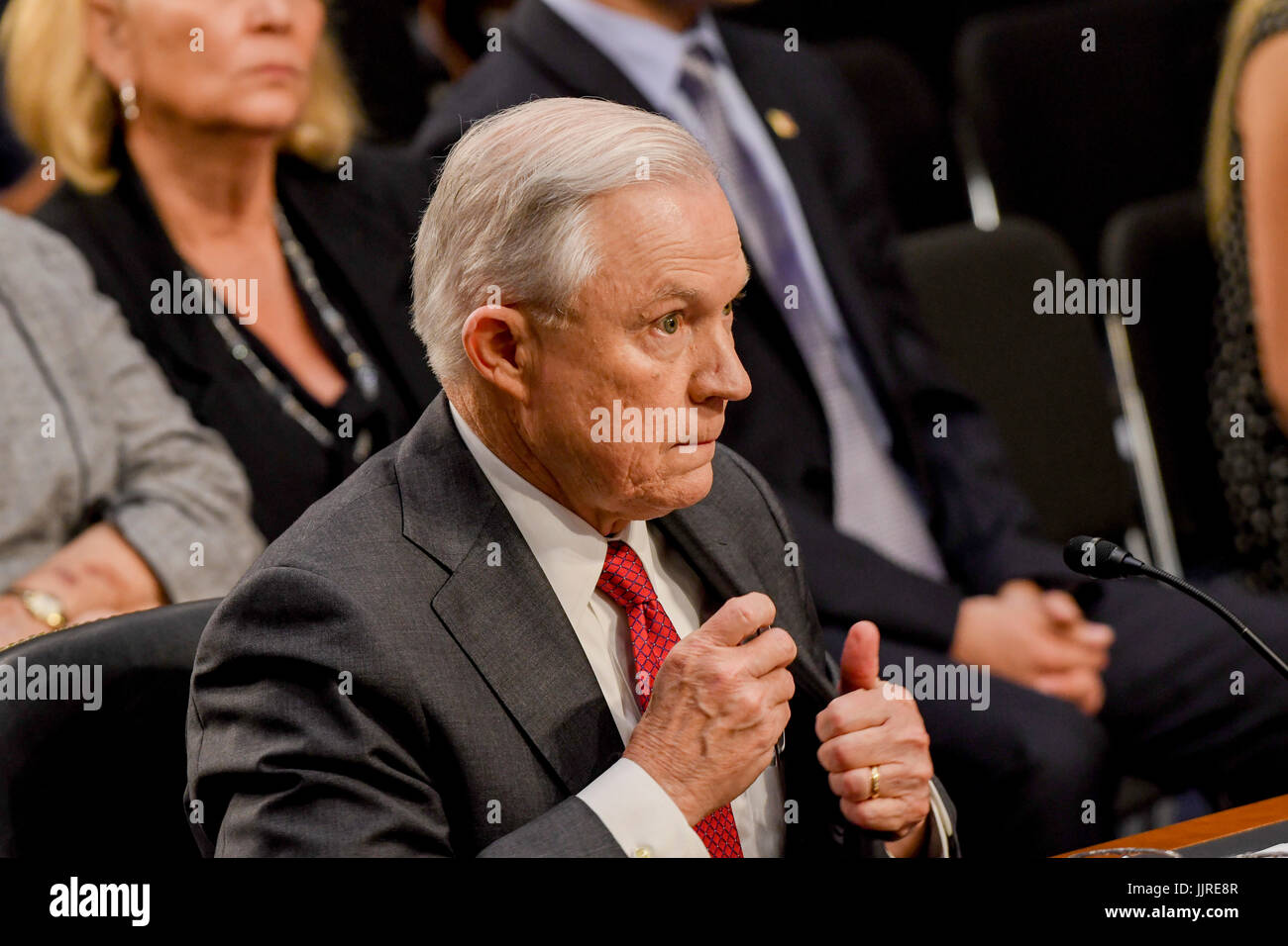 US. Attorney General Jeff Sessions removes his reading glasses after reading his prepared opening statements at the start of his testimony in front of the Senate Intelligence  Committee. Washington DC, June 13, 2017. Stock Photo