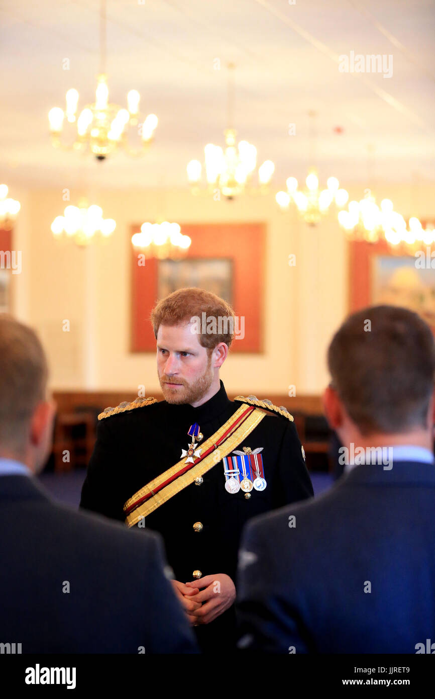 Prince Harry talks to service personnel after he presented the Firmin Sword of Peace to the Royal Air Force Police during an official visit to RAF Honington in Bury St Edmunds. Stock Photo