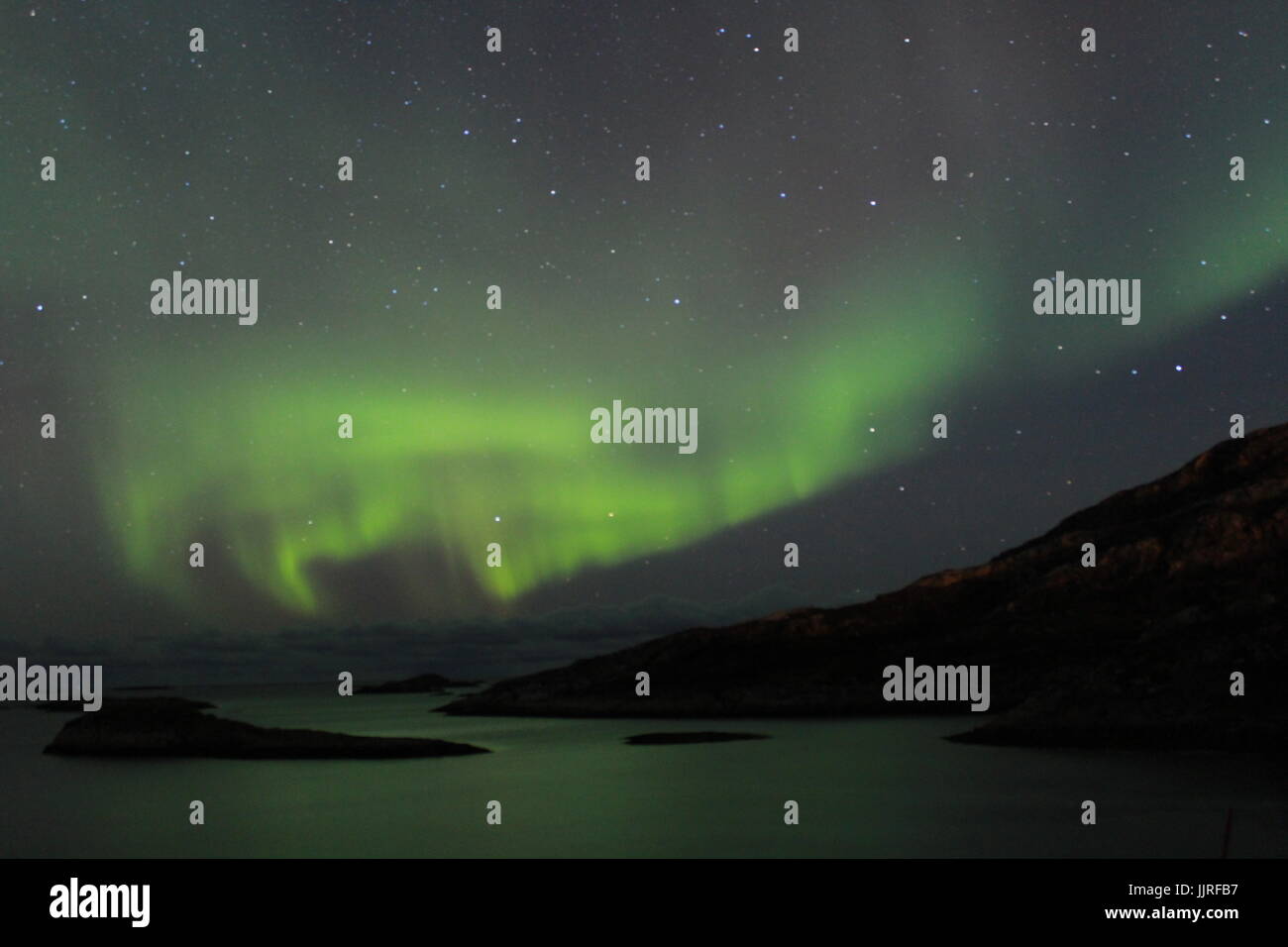 Northern lights over the Fjords in Tromso Stock Photo