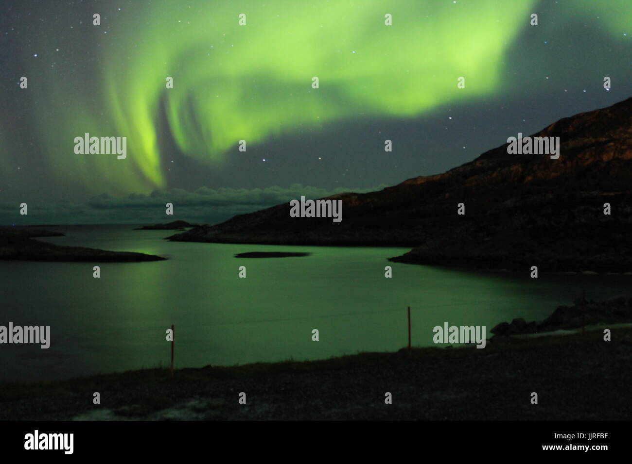 Northern lights over the Fjords in Tromso Stock Photo - Alamy