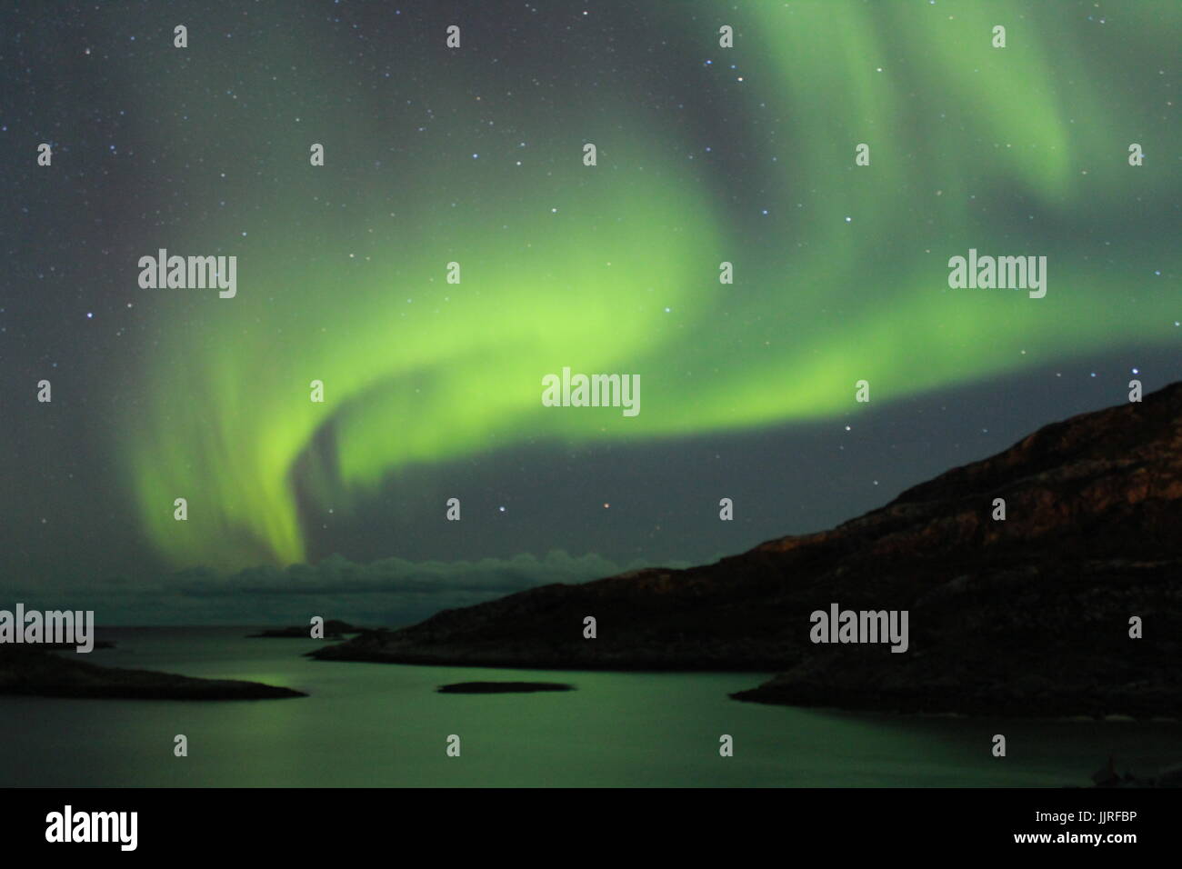 Northern lights over the Fjords in Tromso Stock Photo