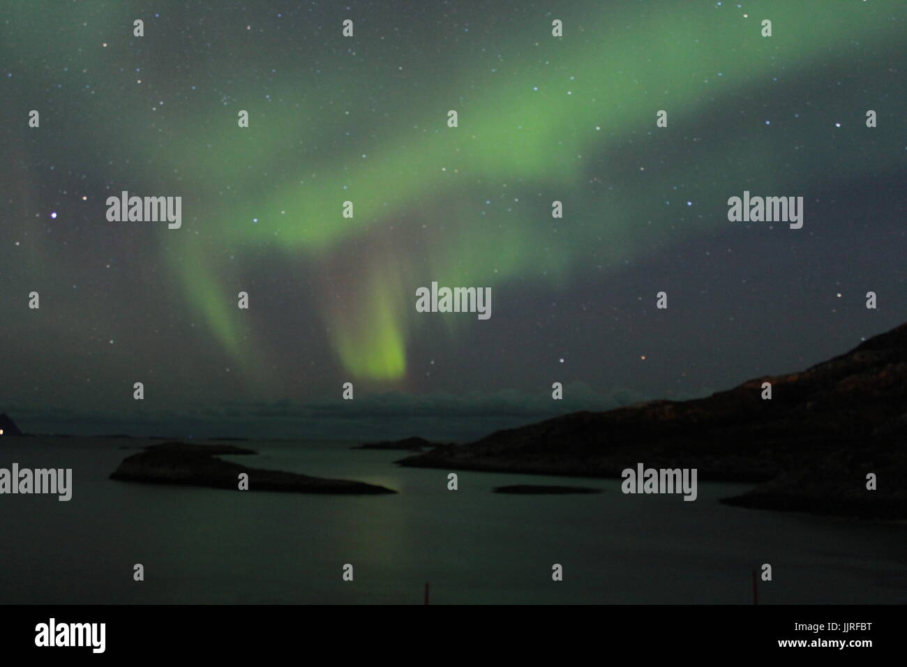 Northern lights over the Fjords in Tromso Stock Photo