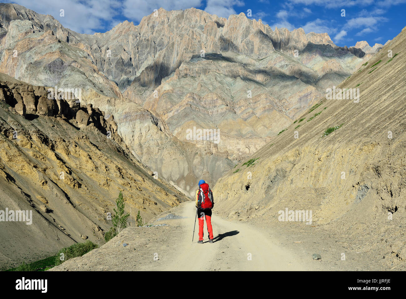 Tourist during expedition in the mountains Ladakh is admiring the beautiful Karakorum panorama Stock Photo