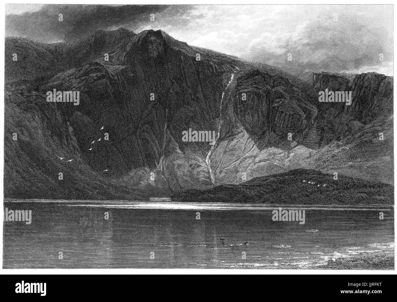 1870: Llyn Idwal is a small lake that lies within Cwm Idwal in the Glyderau mountains of Snowdonia, Gwynd, North Wales. Stock Photo