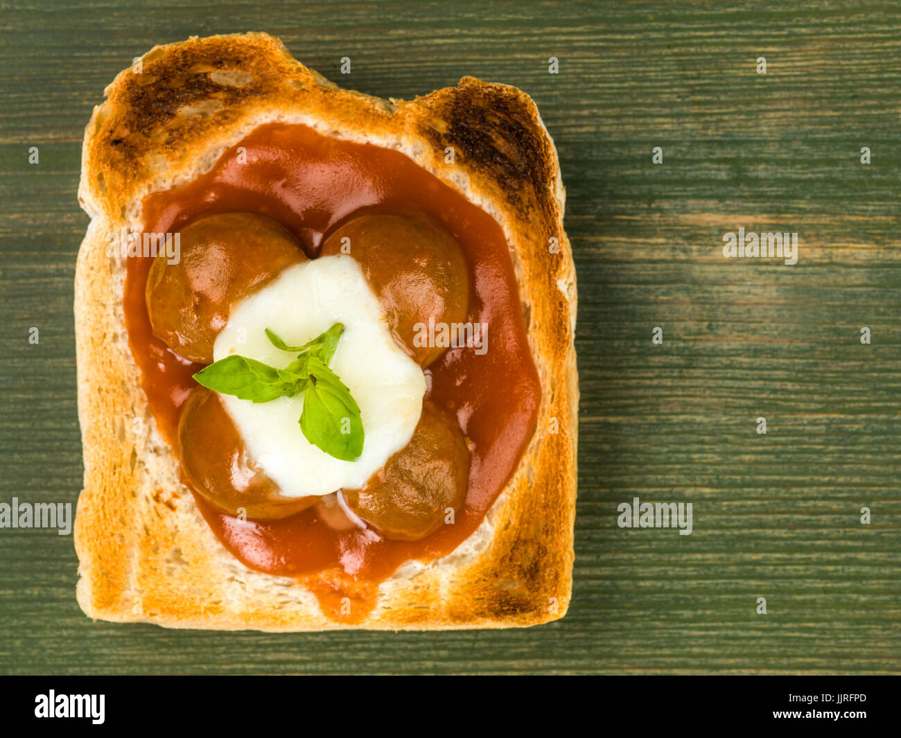 Meatballs in Tomato Sauce With Mozzarella Cheese on Toast Against a