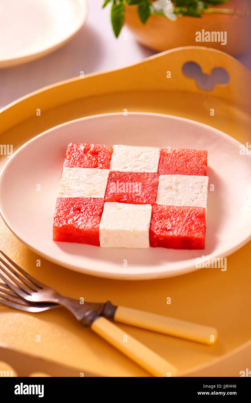 Cubes of watermelon and feta cheese on a plate forming a square pattern. Stock Photo