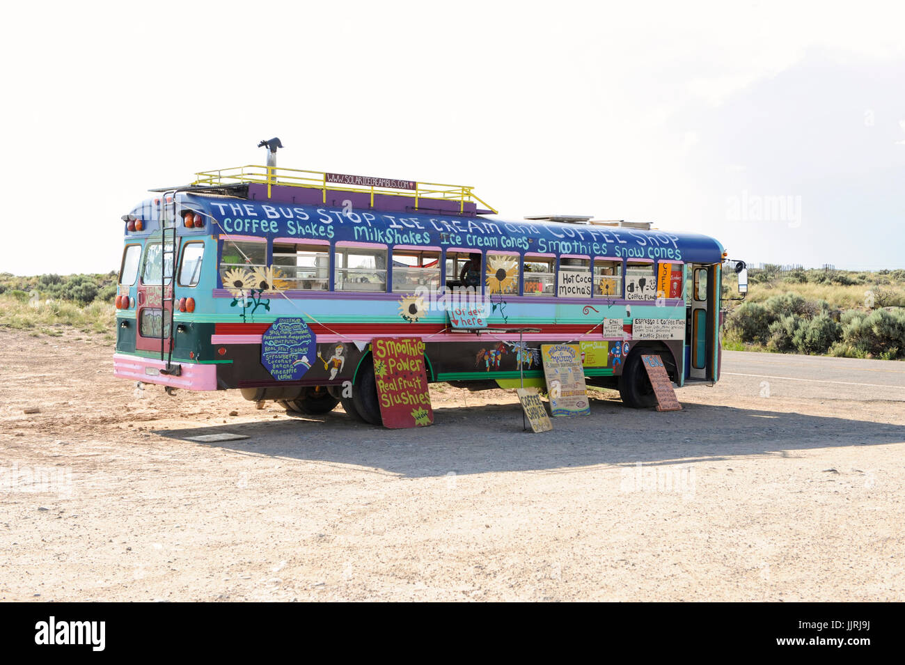 Food vender in a custom painted school bus near the Rio Grande Gorge, Taos, New Mexico Stock Photo