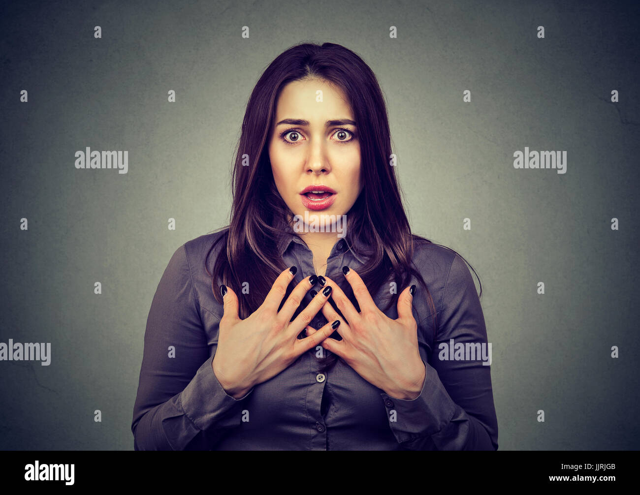 Stunned young woman looking at camera Stock Photo