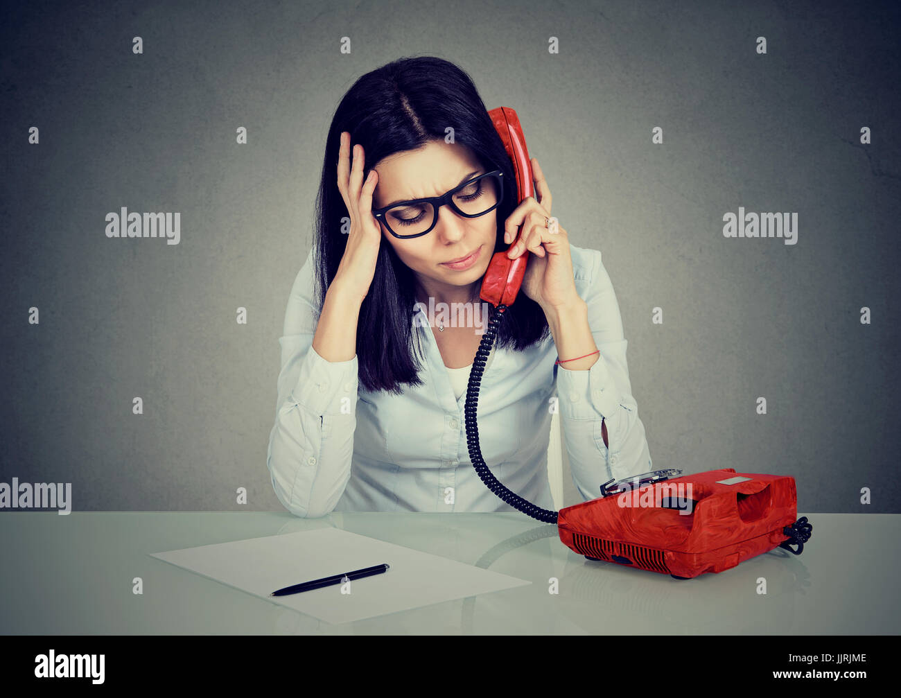 Serious stressed business woman on the phone Stock Photo
