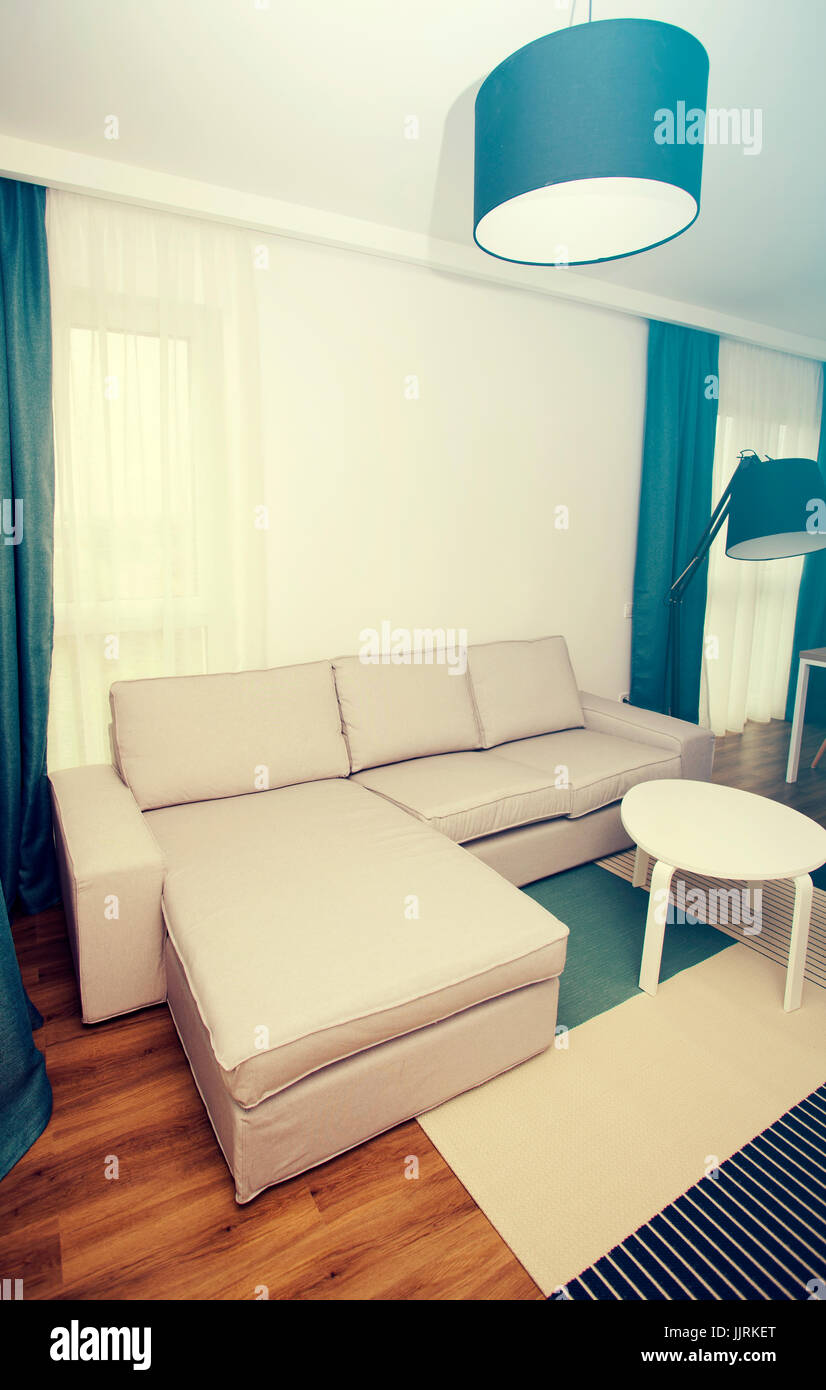 Cozy and bright living room with sofa and furniture Stock Photo - Alamy