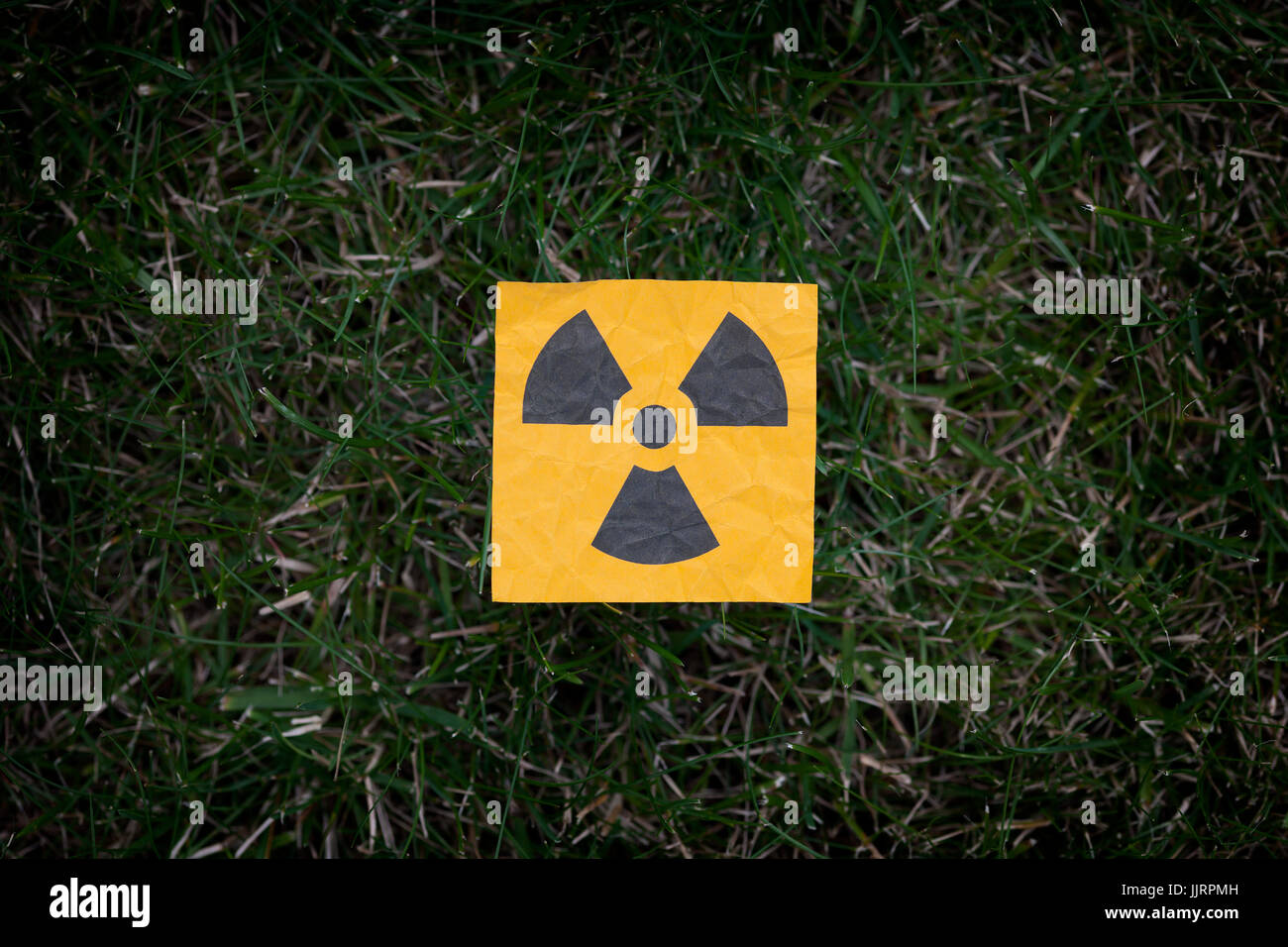 Radiation warning sign on a green grass Stock Photo - Alamy