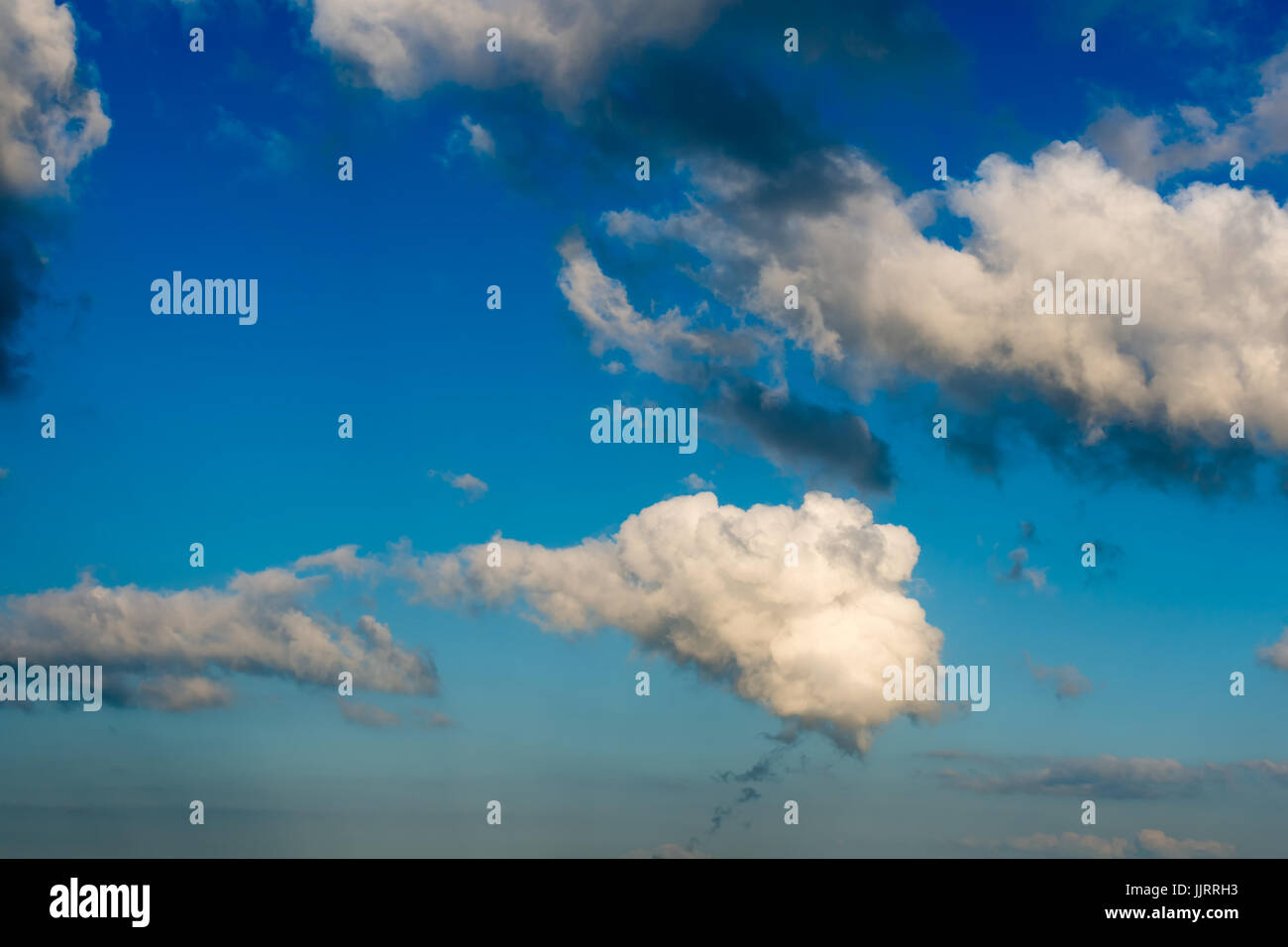 Fantastic white clouds against blue sky Stock Photo - Alamy