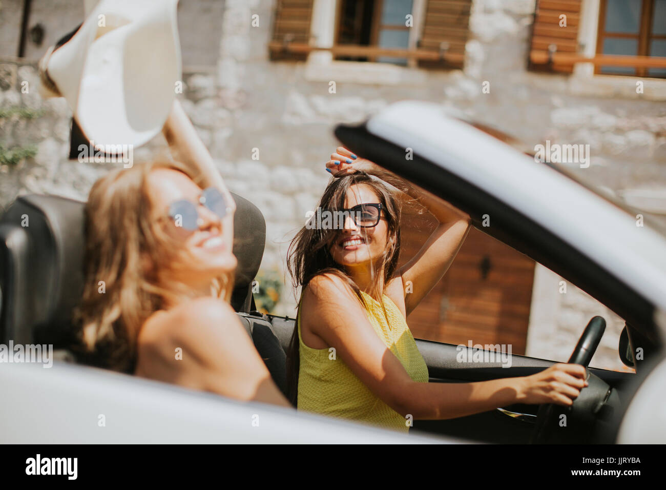 Female Driver Fun Pretty young women driving and having fun in white cabriolet car Stock ...