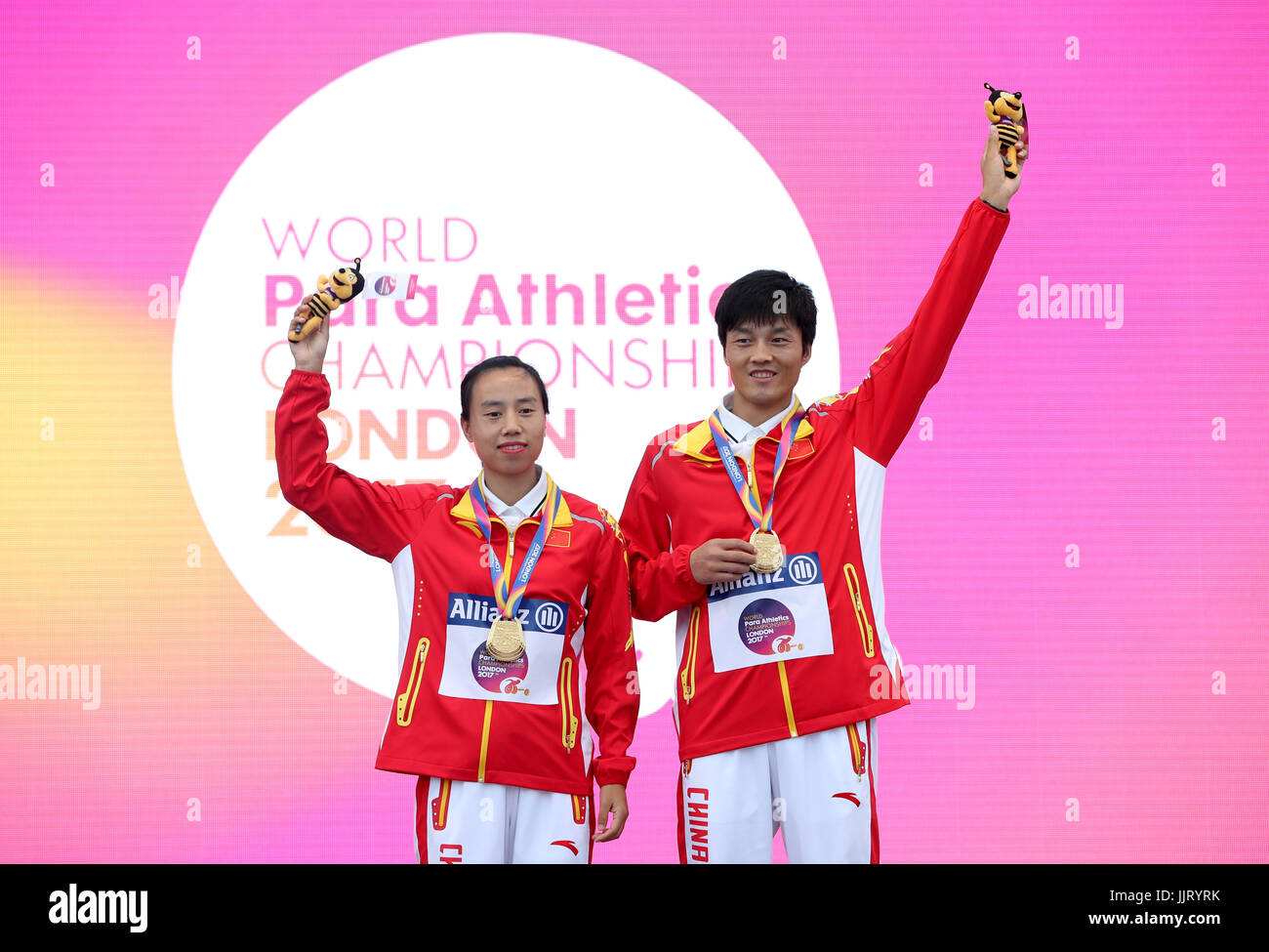 China's Guohua Zhou (left) and guide Dengpu Jia with their gold medals ...