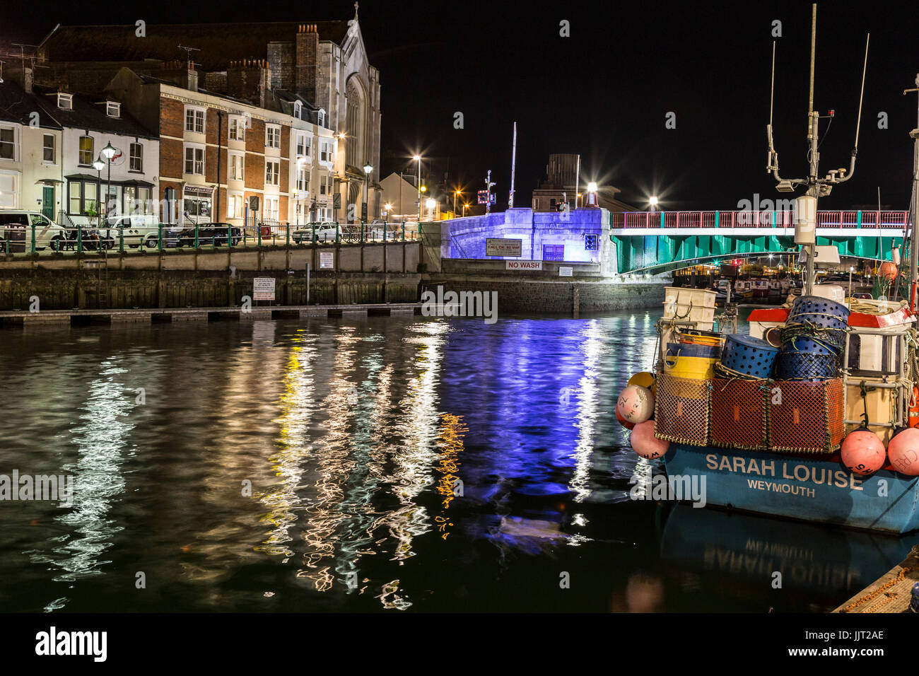 weymouth old harbour dusk into night on the river wey boats and harbour side colourful houses