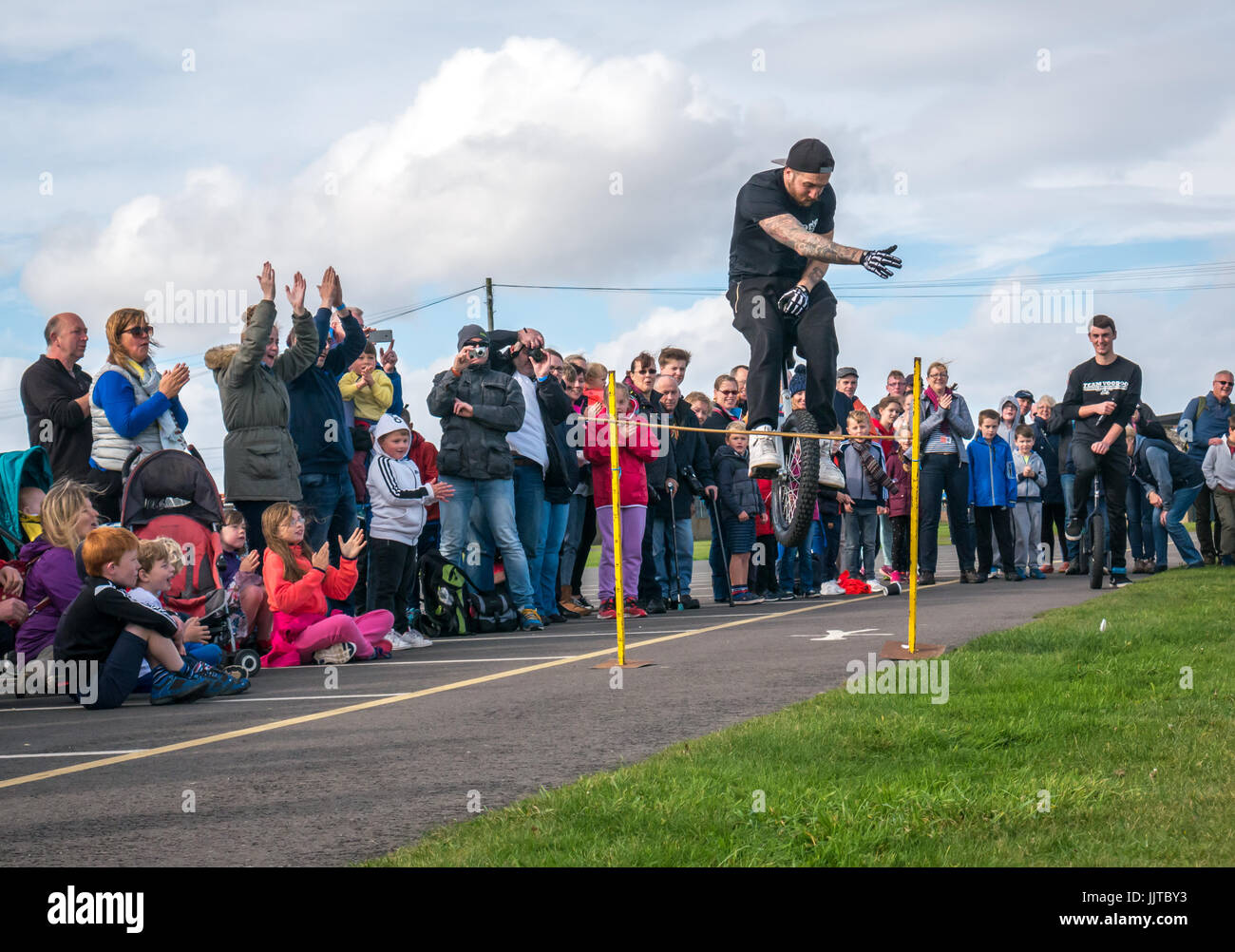 Jason Auld of Team Voodoo unicycles performing stunt leap at Wheels and Wings event 2016, East Fortune, East Lothian, Scotland, UK Stock Photo