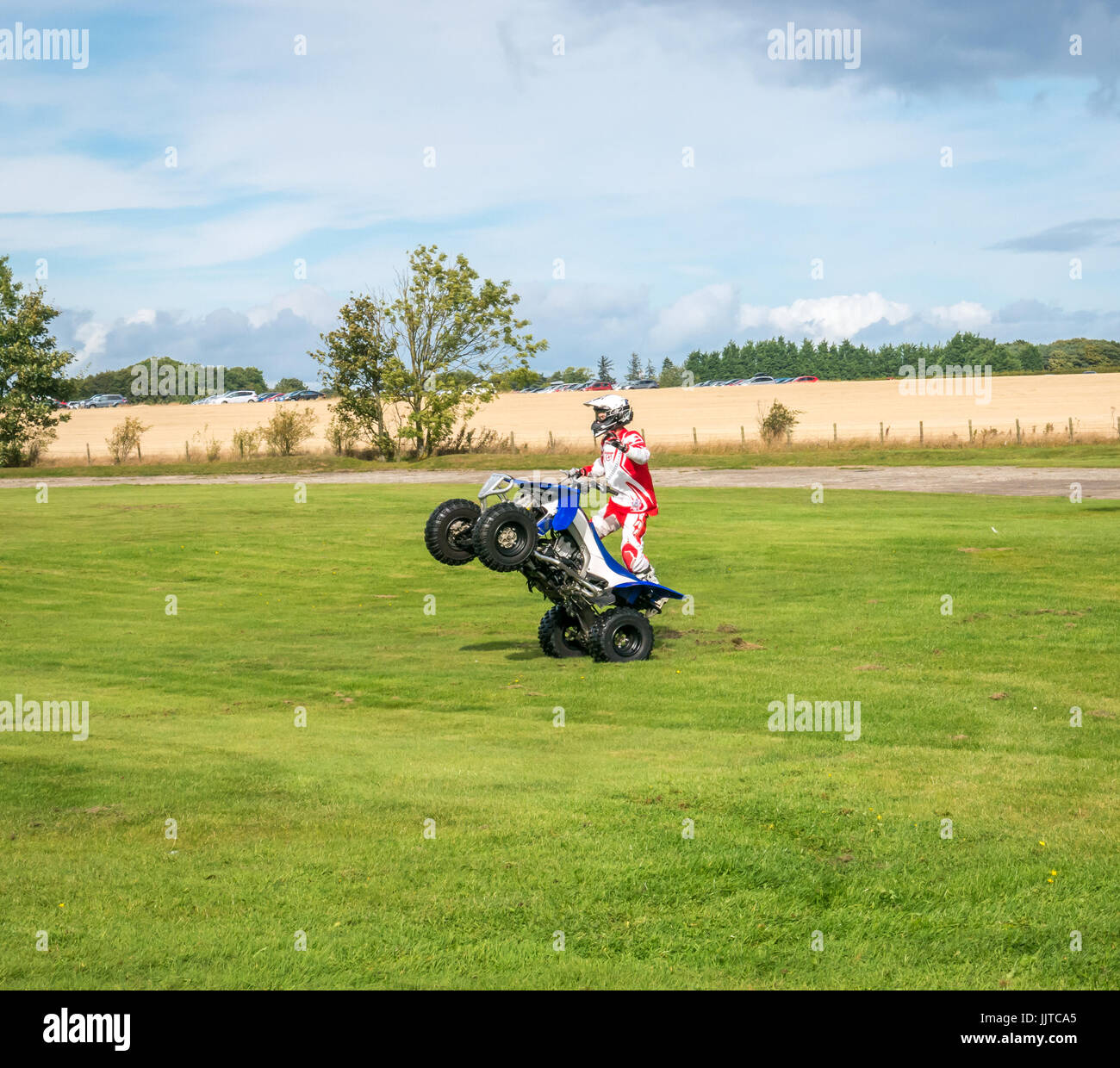 Jason Smyth stuntman performing quad bike stunt at Wheels and Wings family event 2016, East Fortune, East Lothian, Scotland, UK Stock Photo