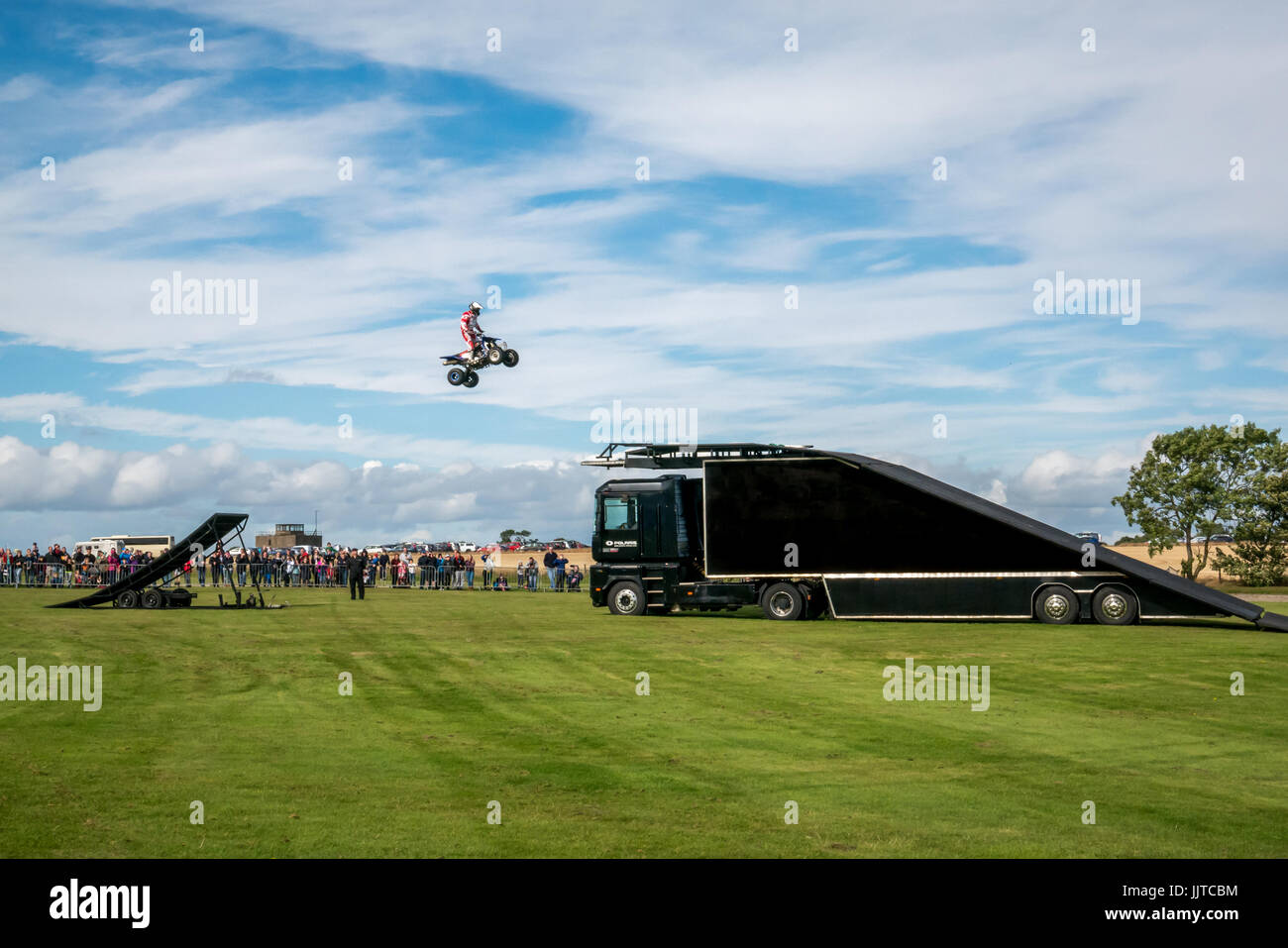 Jason Smyth stuntman performing quad bike leap stunt at Wheels and Wings family event 2016, East Fortune, East Lothian, Scotland, UK Stock Photo
