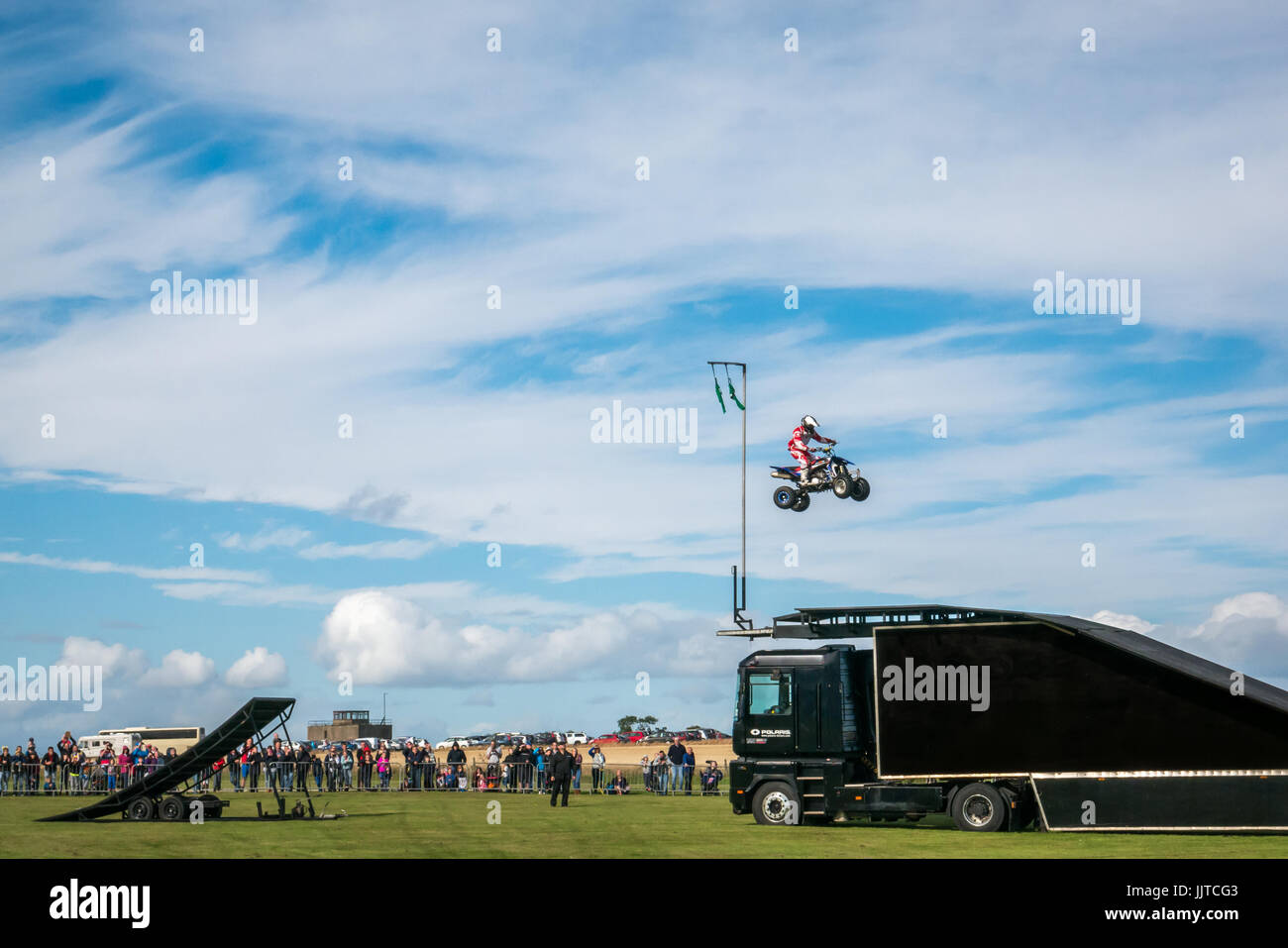 Jason Smyth stuntman performing quad bike leap stunt, Wheels and Wings family event 2016, East Fortune, East Lothian, Scotland, UK Stock Photo