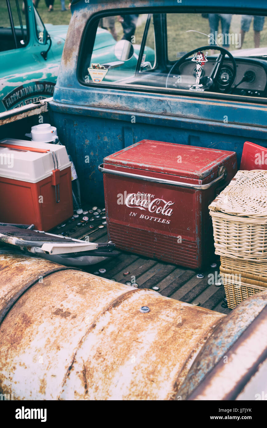 Old retro Coca Cola cool box in the back of a vintage american pick up truck at Rally of the Giants american car show, Blenheim palace, Oxfordshire UK Stock Photo