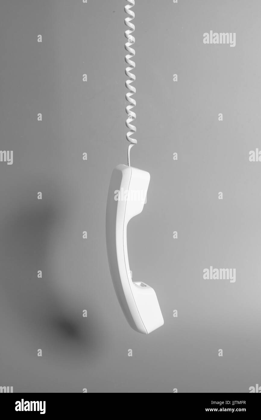 Telephone receiver and cord on gray background Stock Photo Alamy