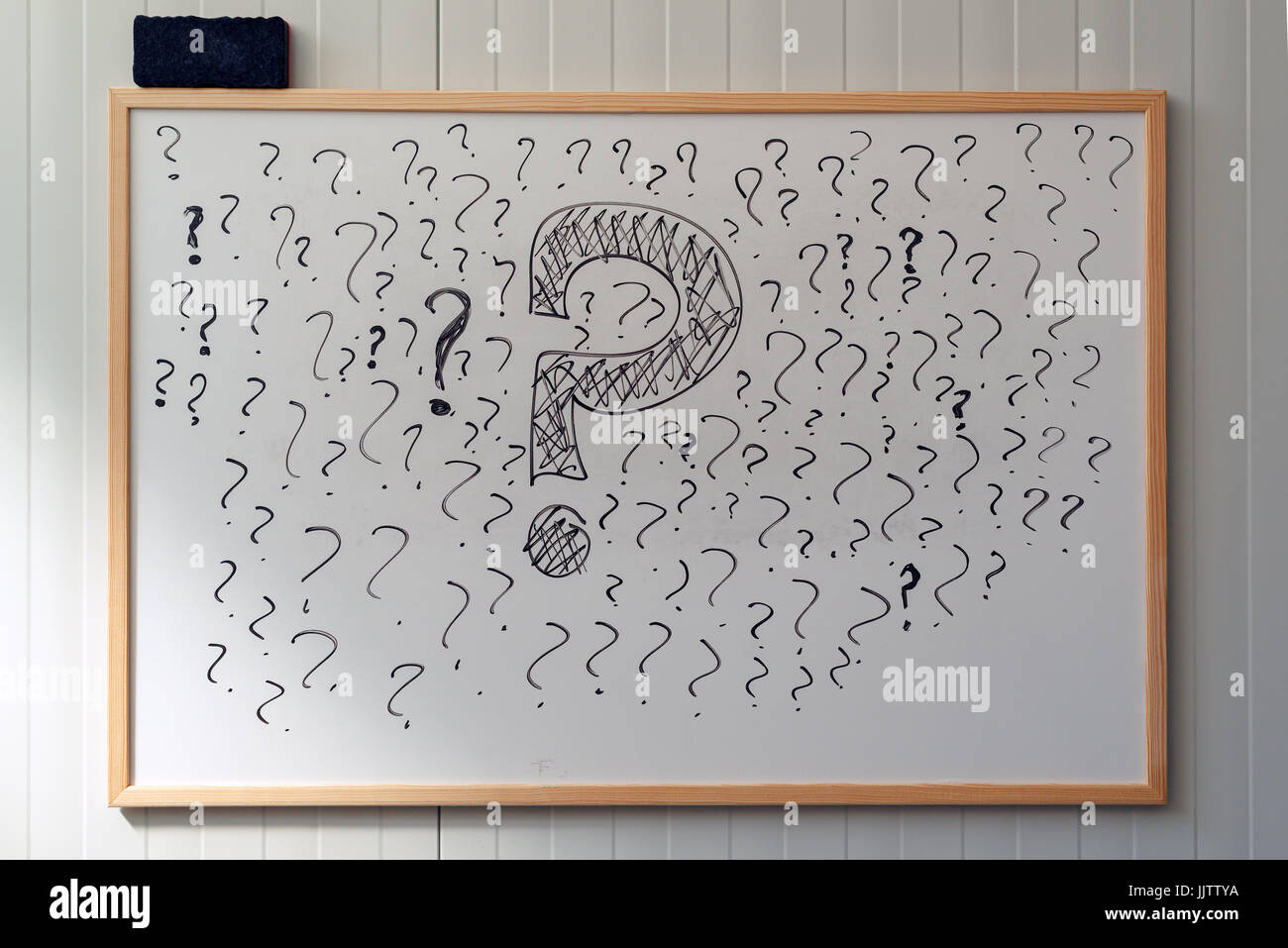 Many question marks on office whiteboard, uncertainty and unpredictability in business Stock Photo