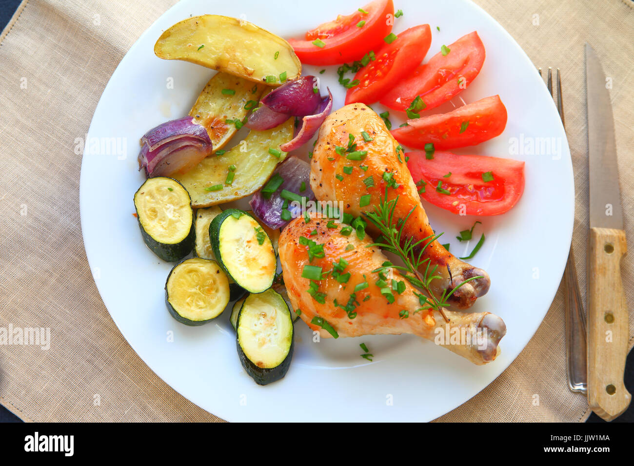 Roasted chicken legs with tomatoes, fingerling potatoes, onions