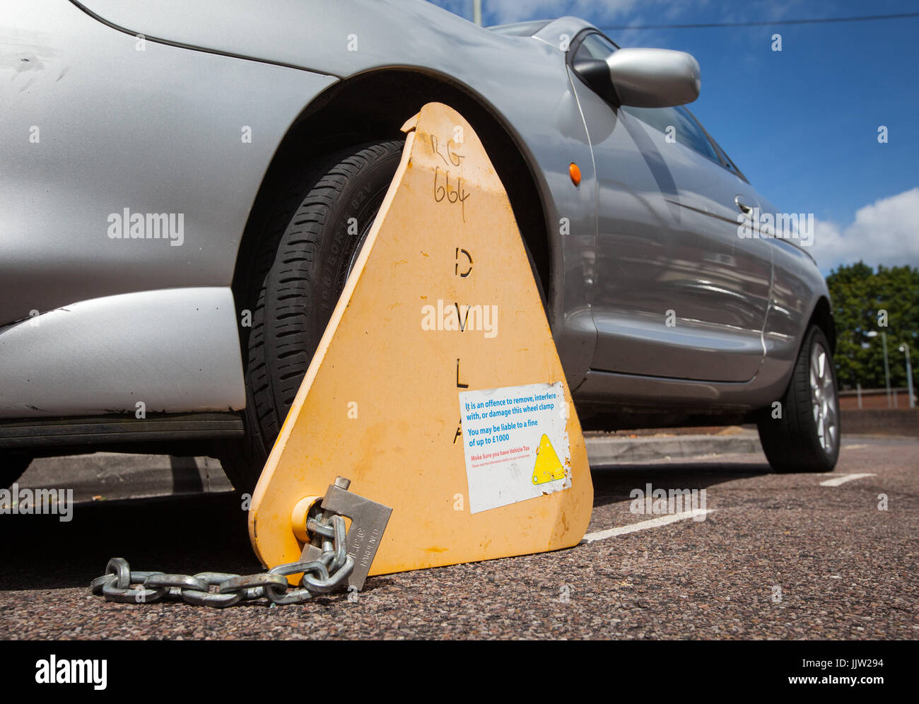 An untaxed car clamped by the DVLA Stock Photo