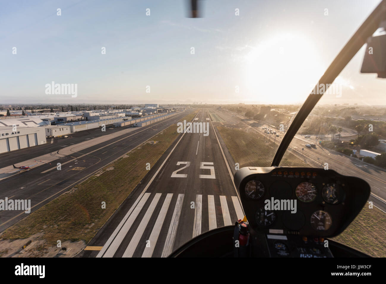 Hawthorne, California, USA - July 10, 2017:  Afternoon view inside helicopter approaching airport runway. Stock Photo