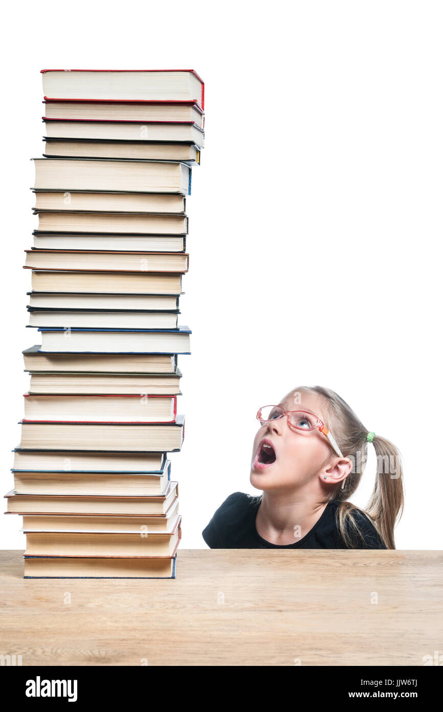 Surprised schoolgirl looking at book Stock Photo - Alamy