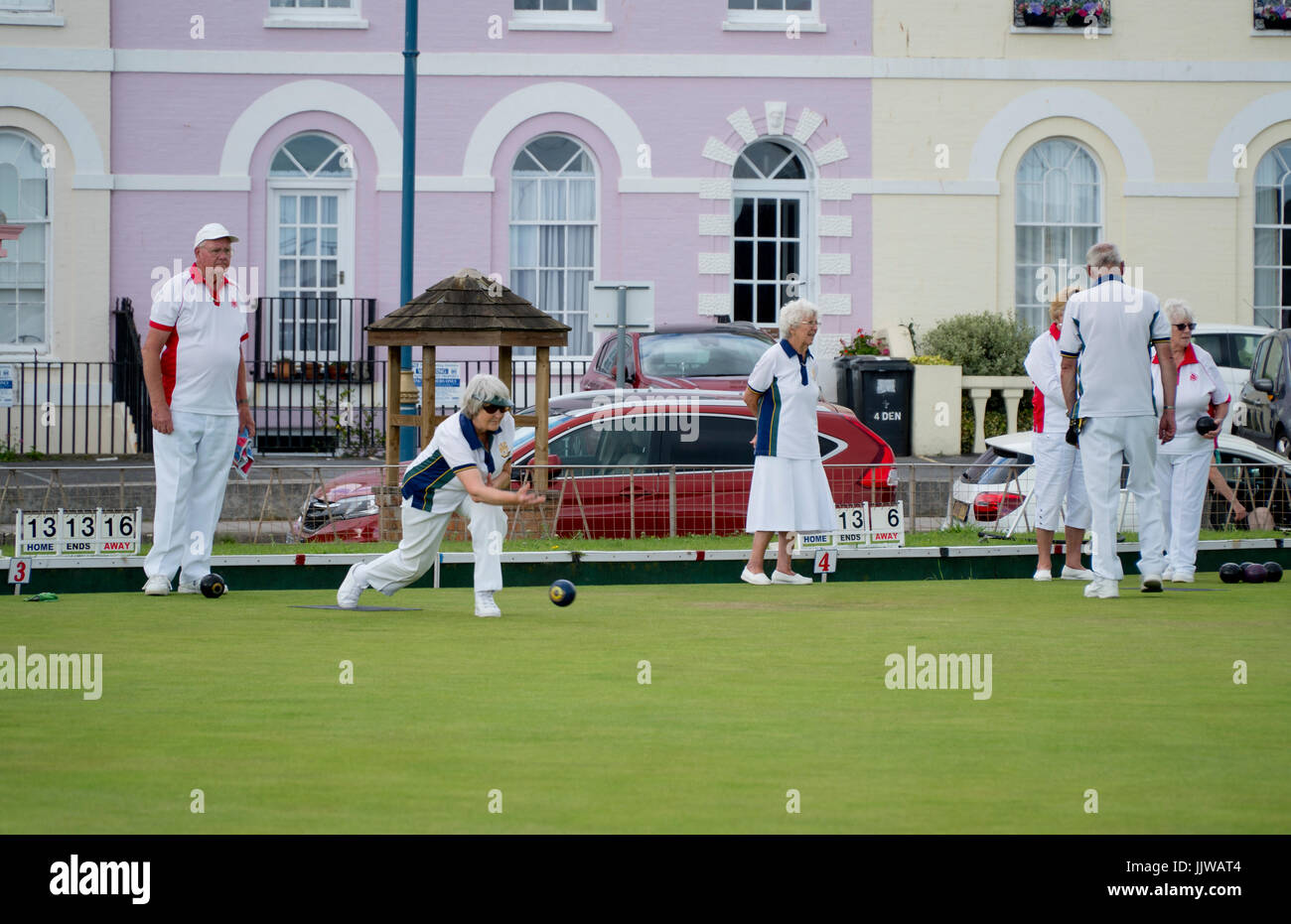 Men and women playing a game of lawn bowls in Teignmouth, Devon