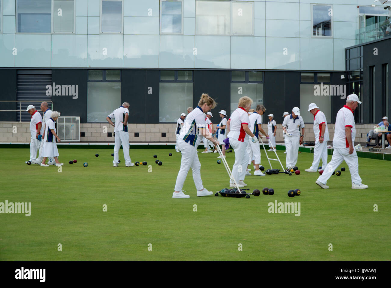 Men and women playing a game of lawn bowls in Teignmouth, Devon, England Stock Photo