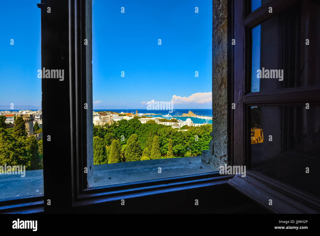 Looking at the old town and shoreline out the window of the Rhodes Castle on the island of Rhodes, Greece in the Mediterranean sea. Stock Photo