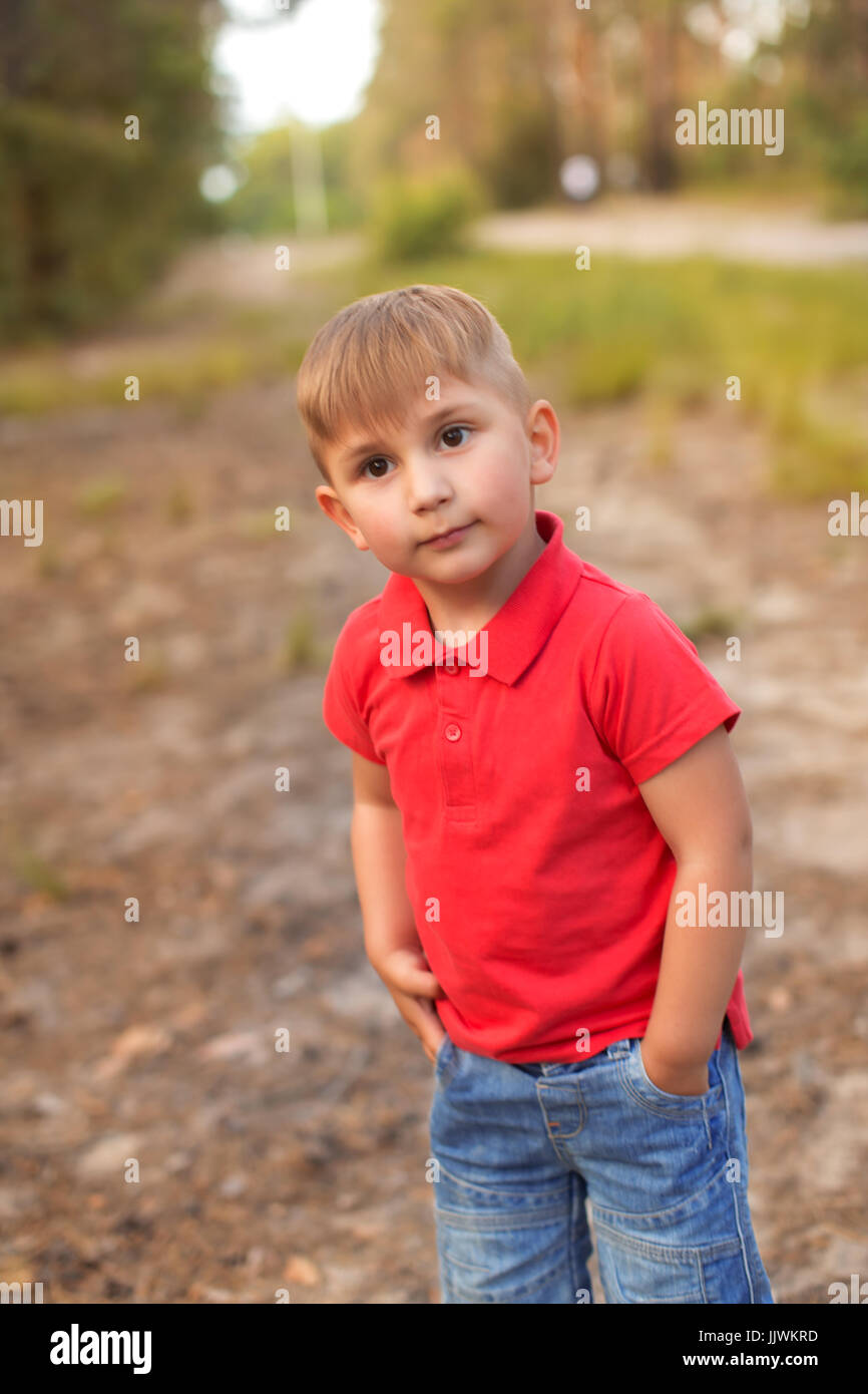 A cute boy in a summer park Stock Photo