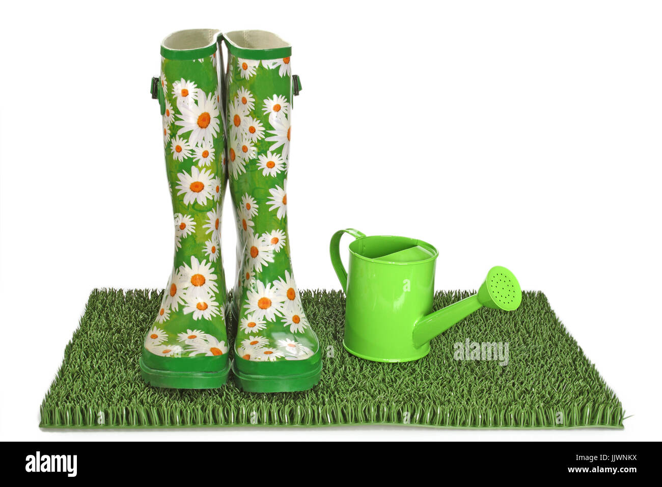 Pair of black rubber boots on green grass Stock Photo - Alamy