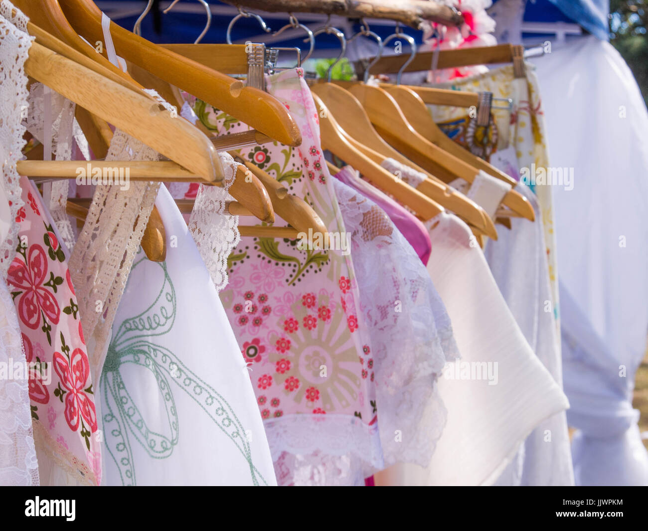 Vintage Women's dresses hanging on a Clothes Rack at a Market Stall