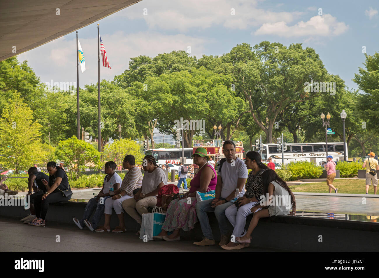 Washington, DC - Visitors to the National Museum of African American History and Culture sit by a pool outside the museum. Stock Photo