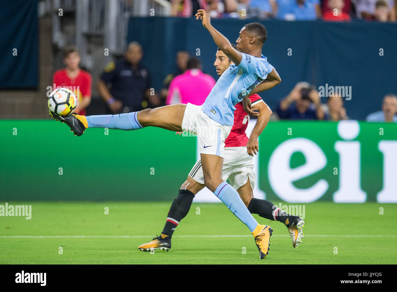 Houston, TX, USA. 20th July, 2017. Manchester City defender John Stones (5) controls the ball in front of Manchester United midfielder Henrikh Mkhitaryan (22) during the 1st half of an International Champions Cup soccer match between Manchester United and Manchester City at NRG Stadium in Houston, TX. Trask Smith/CSM/Alamy Live News Stock Photo