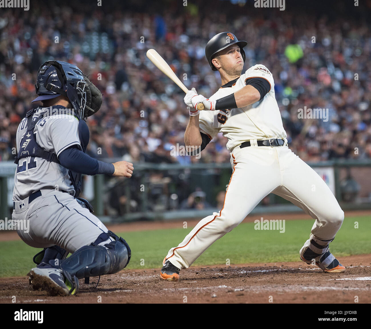 San Francisco, California, USA. 20th July, 2017. San Francisco Giants catcher Buster Posey (28) takes an inside first pitch in the fourth inning, during a MLB game between the San Diego Padres and the San Francisco Giants at AT&T Park in San Francisco, California. Valerie Shoaps/CSM/Alamy Live News Stock Photo