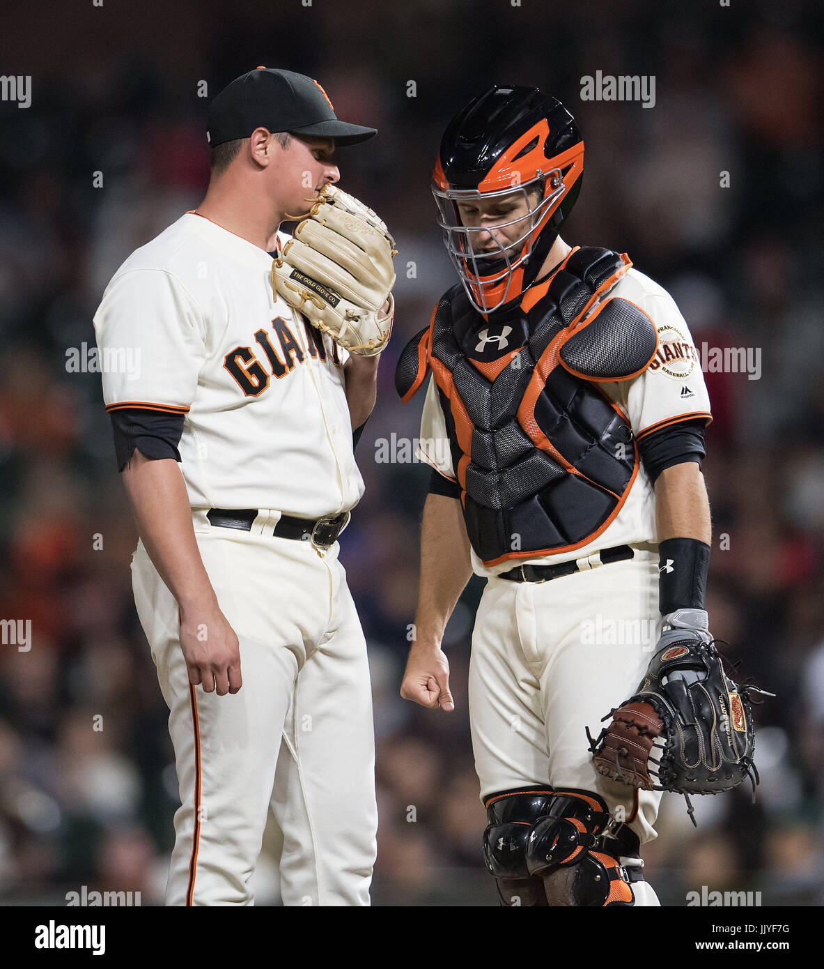 San Francisco, California, USA. 20th July, 2017. San Francisco Giants relief pitcher Kyle Crick (59) and catcher Buster Posey (28) have a quick talk on the mound, during a MLB game between the San Diego Padres and the San Francisco Giants at AT&T Park in San Francisco, California. Valerie Shoaps/CSM/Alamy Live News Stock Photo